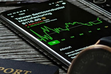 a passport, cell phone, watch and wallet on a table
